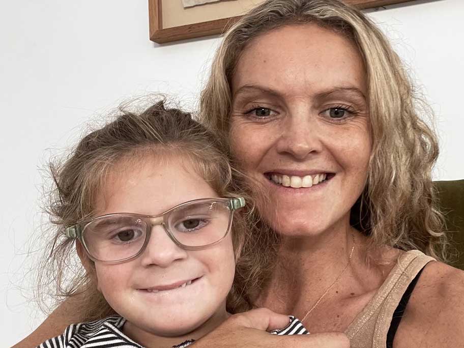 Maeve Hood. who has a mitochondrial disorder, with her mother Sarah.
