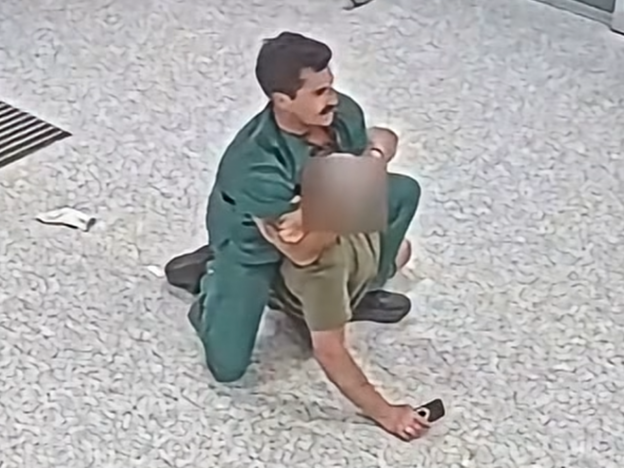 CCTV footage of nurse Daniel Nelson restraining an aggressive patient.